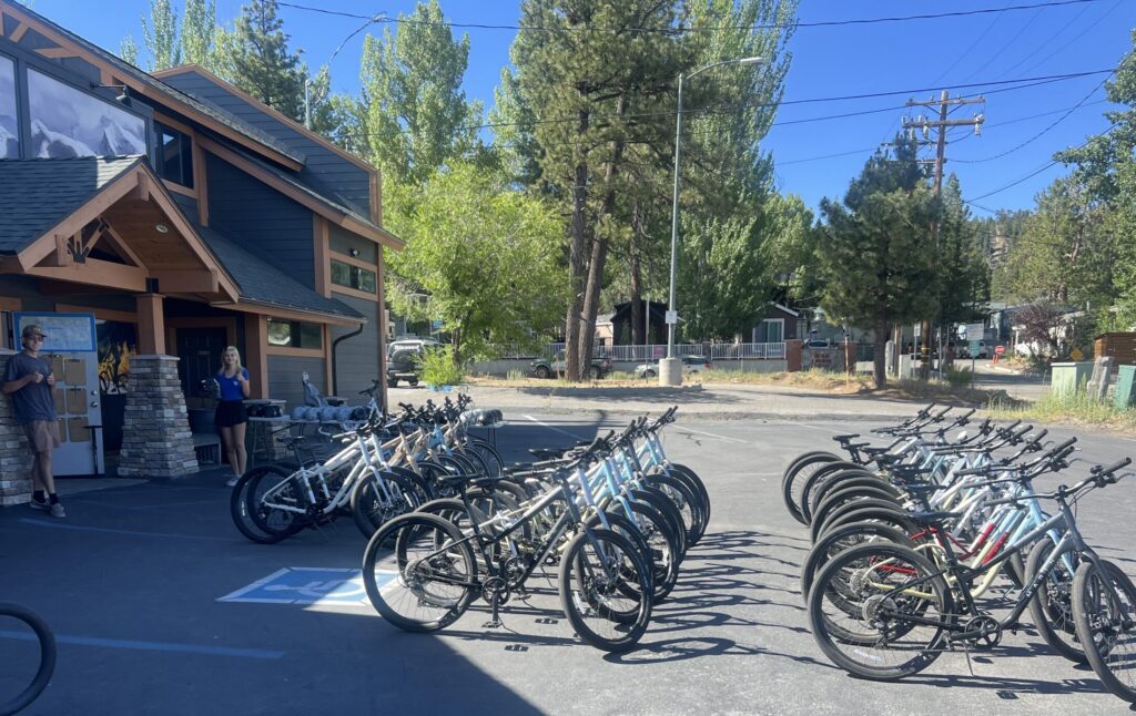 dozens of bikes parked out front of the store at Big Bear Bike Rentals
