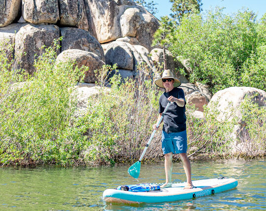 Person paddle boarding on Big Bear Lake in Boulder Bay